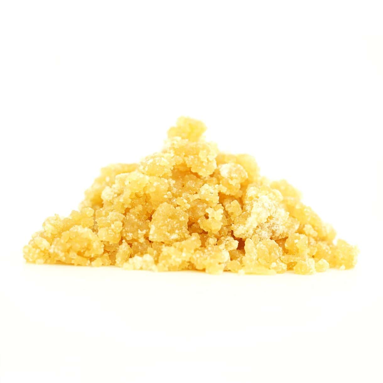 Golden cannabis sugar wax concentrate photographed on a crisp white background with visible crystal texture and natural depth