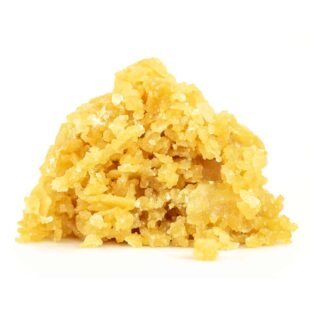 Golden cannabis crumble concentrate with a coarse, crystalline texture on a white background