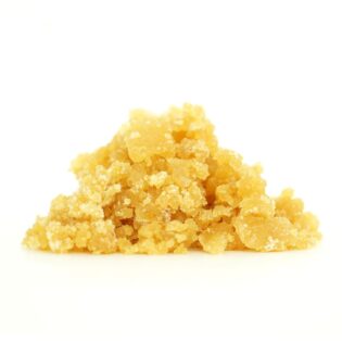 Golden cannabis sugar wax concentrate photographed on a crisp white background with visible crystal texture and natural depth