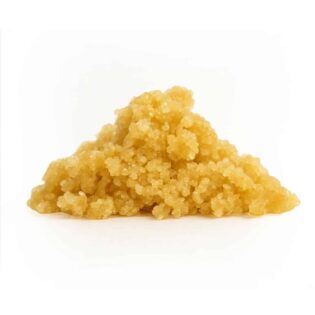 Golden cannabis concentrate crumble on a crisp white background, showcasing its granular texture and photorealistic detail.