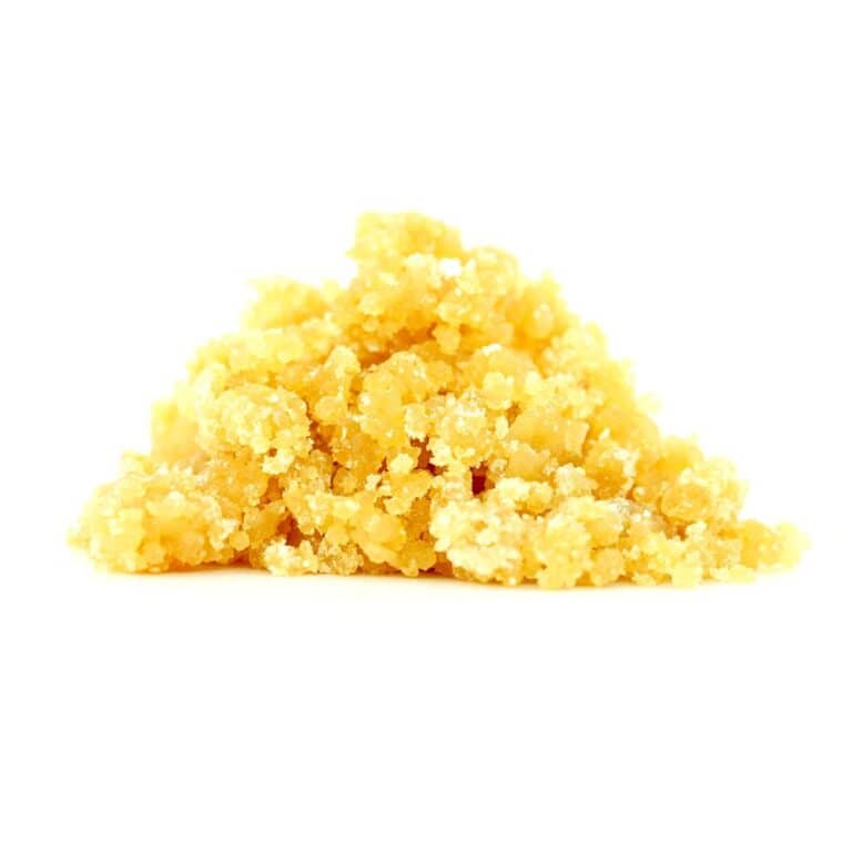 Golden cannabis sugar wax concentrate photographed on a crisp white background with visible crystal texture and natural depth