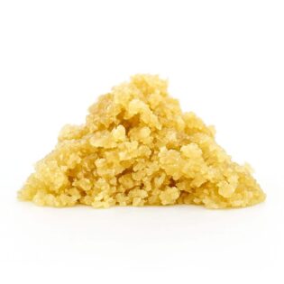 Golden sugar wax concentrate on a crisp white background showcasing its crystalline, grainy texture and natural amber tones.