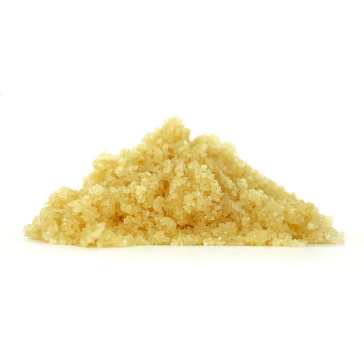 Golden cannabis sugar wax concentrate photographed on a crisp white background with visible crystal texture and natural depth