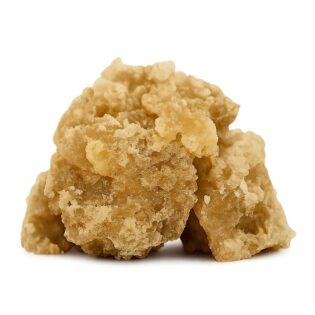 Golden crumbly cannabis concentrate with sticky, crystalline texture on a clean white background