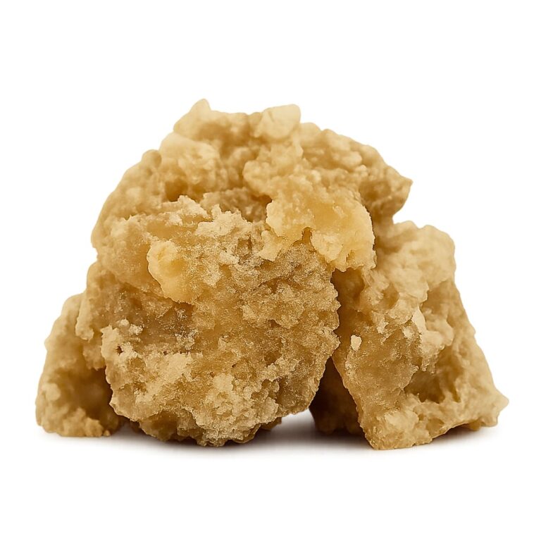 Golden crumbly cannabis concentrate with sticky, crystalline texture on a clean white background