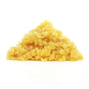 Golden-yellow cannabis concentrate crumble displayed against a clean white background, showcasing its coarse, grainy texture and pyramid-shaped formation.