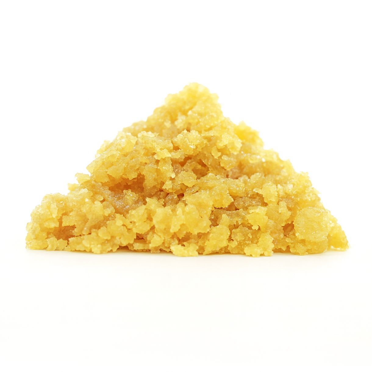 Golden-yellow cannabis concentrate crumble displayed against a clean white background, showcasing its coarse, grainy texture and pyramid-shaped formation.