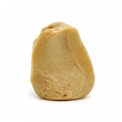 Photorealistic close-up of a light beige resin concentrate with smooth texture and natural contours on a crisp white background.