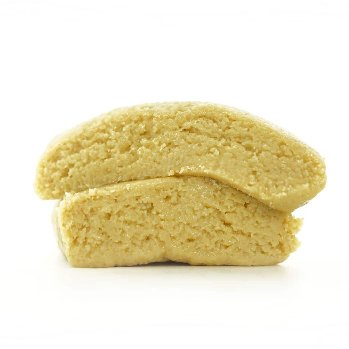 king louie lll Premium light-golden cannabis concentrate with a smooth, dense texture, displayed as a sliced nug-style extract on a clean white background.