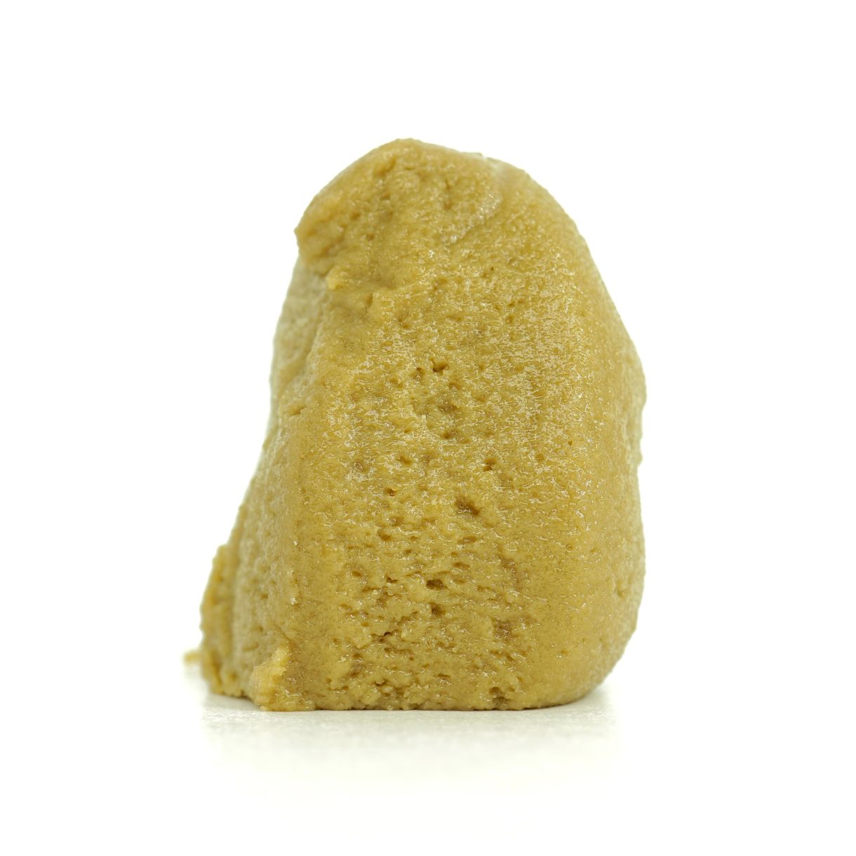 Golden cannabis concentrate hash rosin displayed on a clean white background, showcasing its smooth, dense texture.