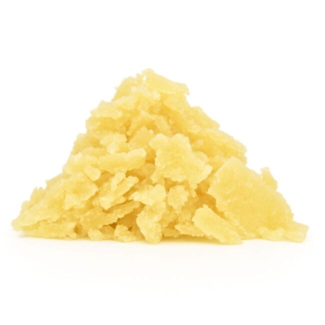 Golden-yellow cannabis concentrate with a flaky, crystalline texture, neatly piled on a clean white background, captured in sharp, natural lighting.