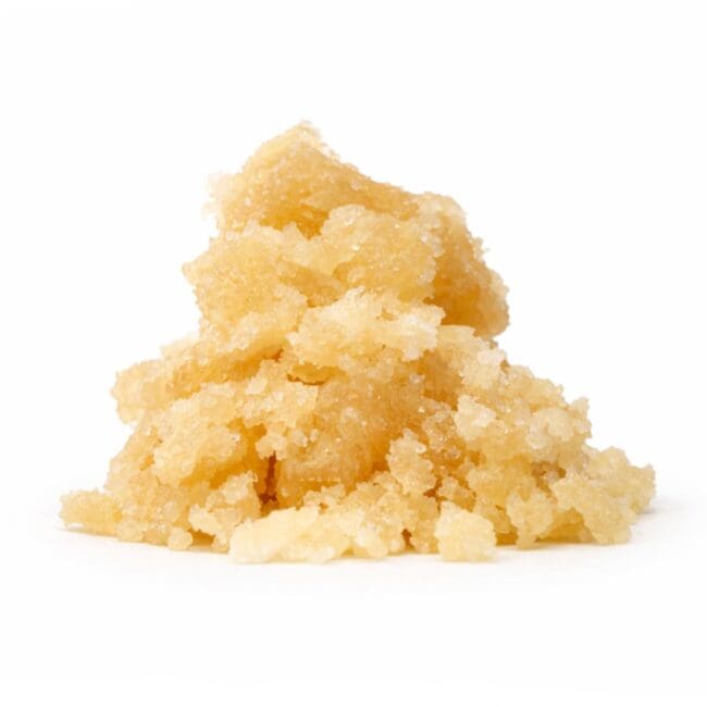 Golden cannabis sugar concentrate with soft crystalline texture on a clean white background