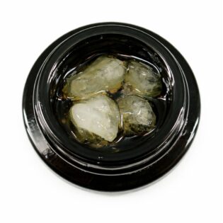 Close-up of cannabis concentrate diamonds in sauce inside a black extract jar on a white background