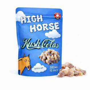 Blue resealable pouch of High Horse Kush Colas cannabis-infused cola bottle gummies with illustrated cloud graphics, THC symbol, and a pile of sugar-coated cola gummies displayed beside the package.
