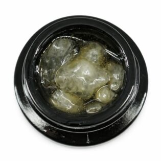 Close-up of cannabis concentrate diamonds in sauce inside a black extract jar on a white background