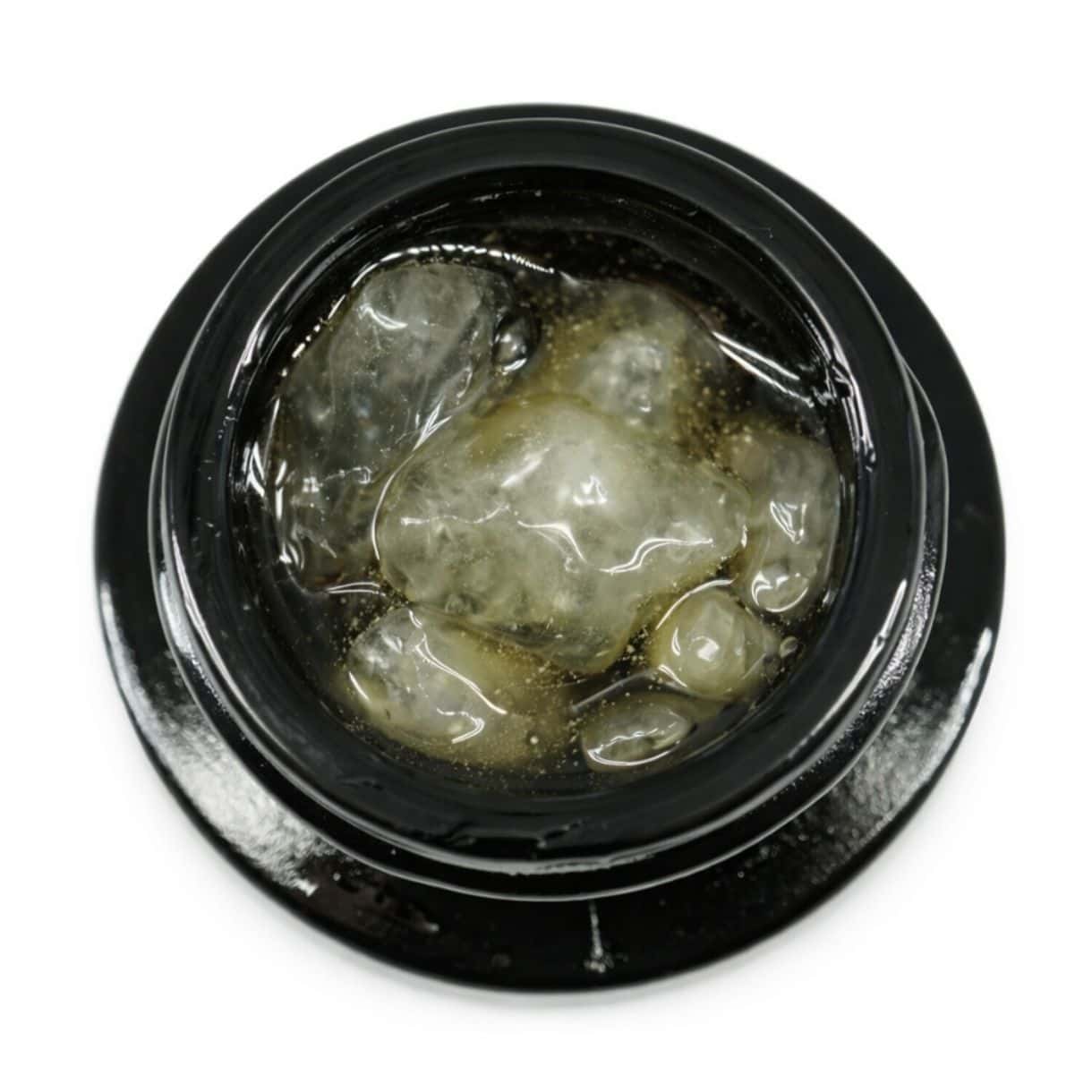 Close-up of cannabis concentrate diamonds in sauce inside a black extract jar on a white background