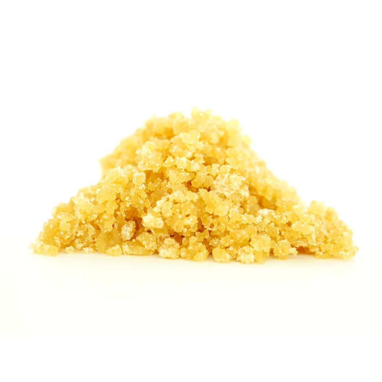 Golden cannabis sugar wax concentrate photographed on a crisp white background with visible crystal texture and natural depth