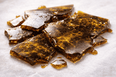 Dark brown bad shatter indicating low-quality extract