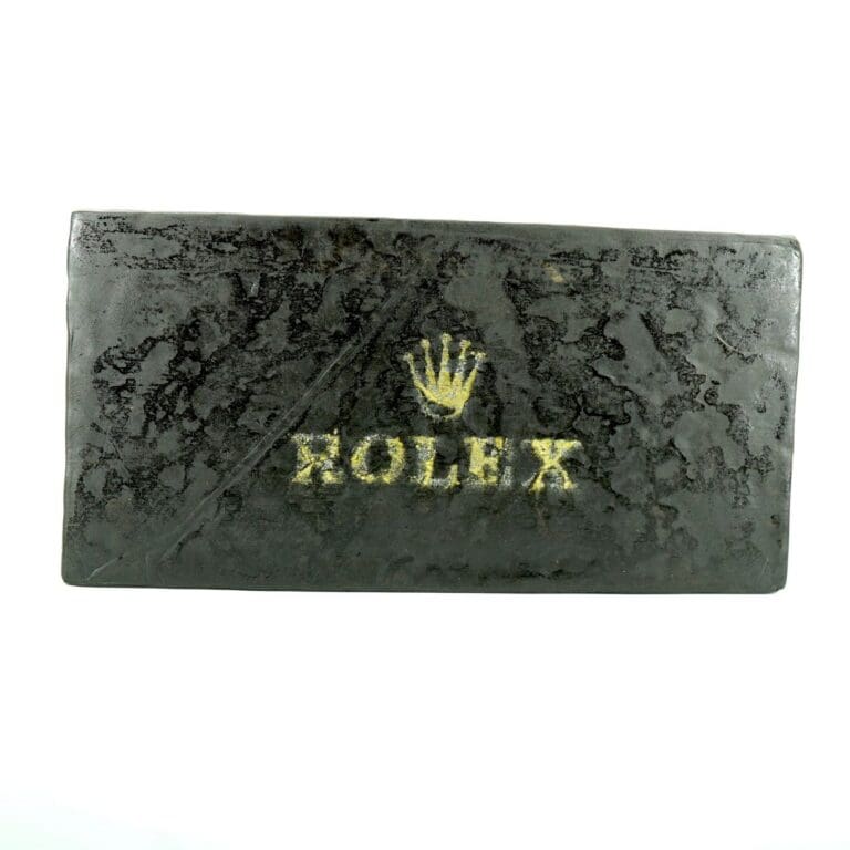 ROLEX hash block featuring a dark marbled finish and embossed branding