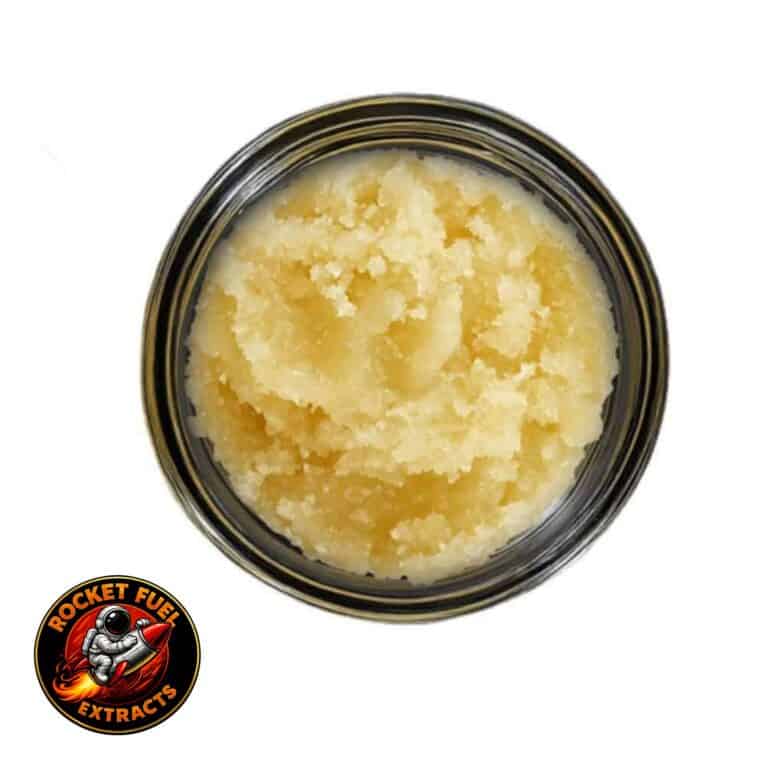 Open jar with golden, crumbly texture and granular consistency (close-up)