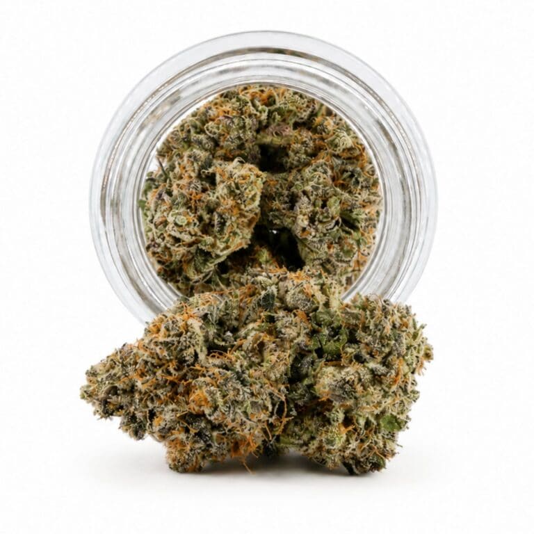 Dense cannabis flower with frosty trichomes in foreground, glass jar softly blurred on a crisp white background