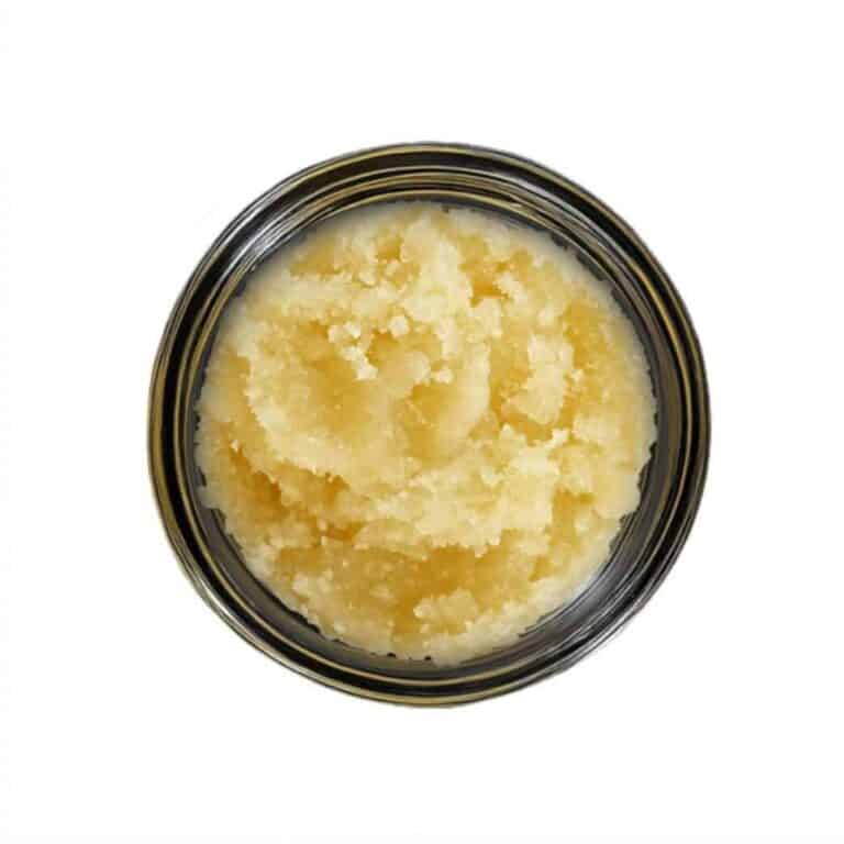 open jar with golden, crumbly texture and granular consistency (close-up)